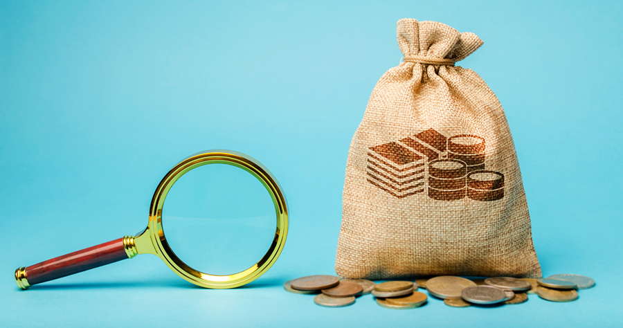 Money bag and magnifying glass. Find a money. The concept of finding sources of investment and sponsors. Charitable funds. Startups and crowdfunding. Search for cheap loans. Business and Finance