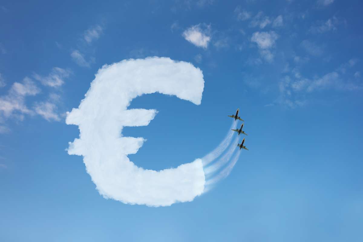 Euro currency buy price growth and volatility concept with sign element made of clouds on blue background over sky, jet plane pull cloud up