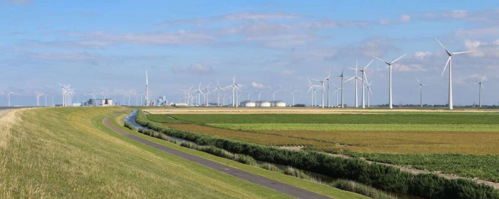 Panoramic summer view of the landscape and multi-fuel power station with wind turbines at Eemshaven, in Groningen, the Netherlands.